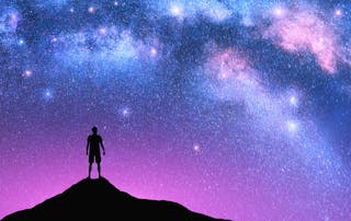 Milky Way arch and man on the mountain peak at starry night. Silhouette of alone guy, pink sky with bright stars