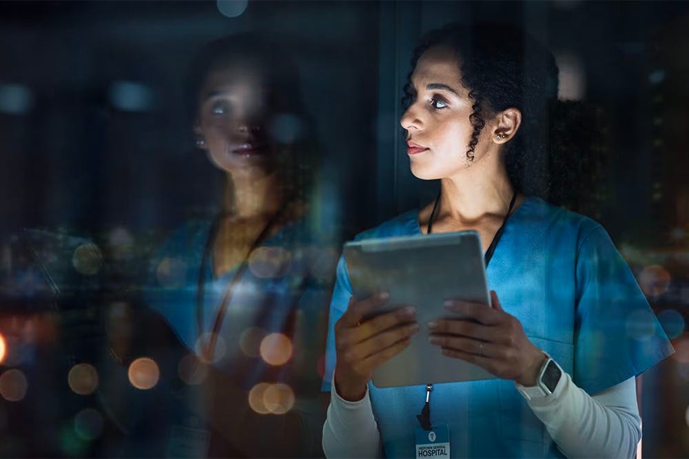VOSS for Life Sciences - healthworker looking out of window at night