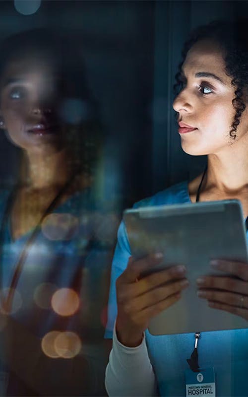 VOSS for Life Sciences - healthworker looking out of window at night
