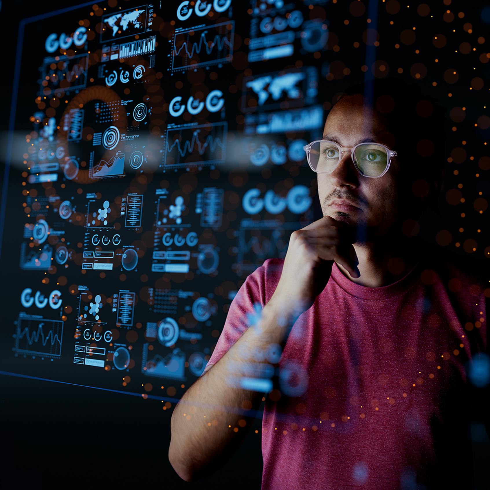 Dark background of Analyst looking at graphical data - used in VOSS blog for Maximizing Business Value with AI in UC: Cost Efficiency and New Opportunities