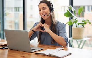 Happy user experience. Woman makes heart shape with hands. VOSS Insights contributes to a seamless and high-quality user experience across your UC environment.