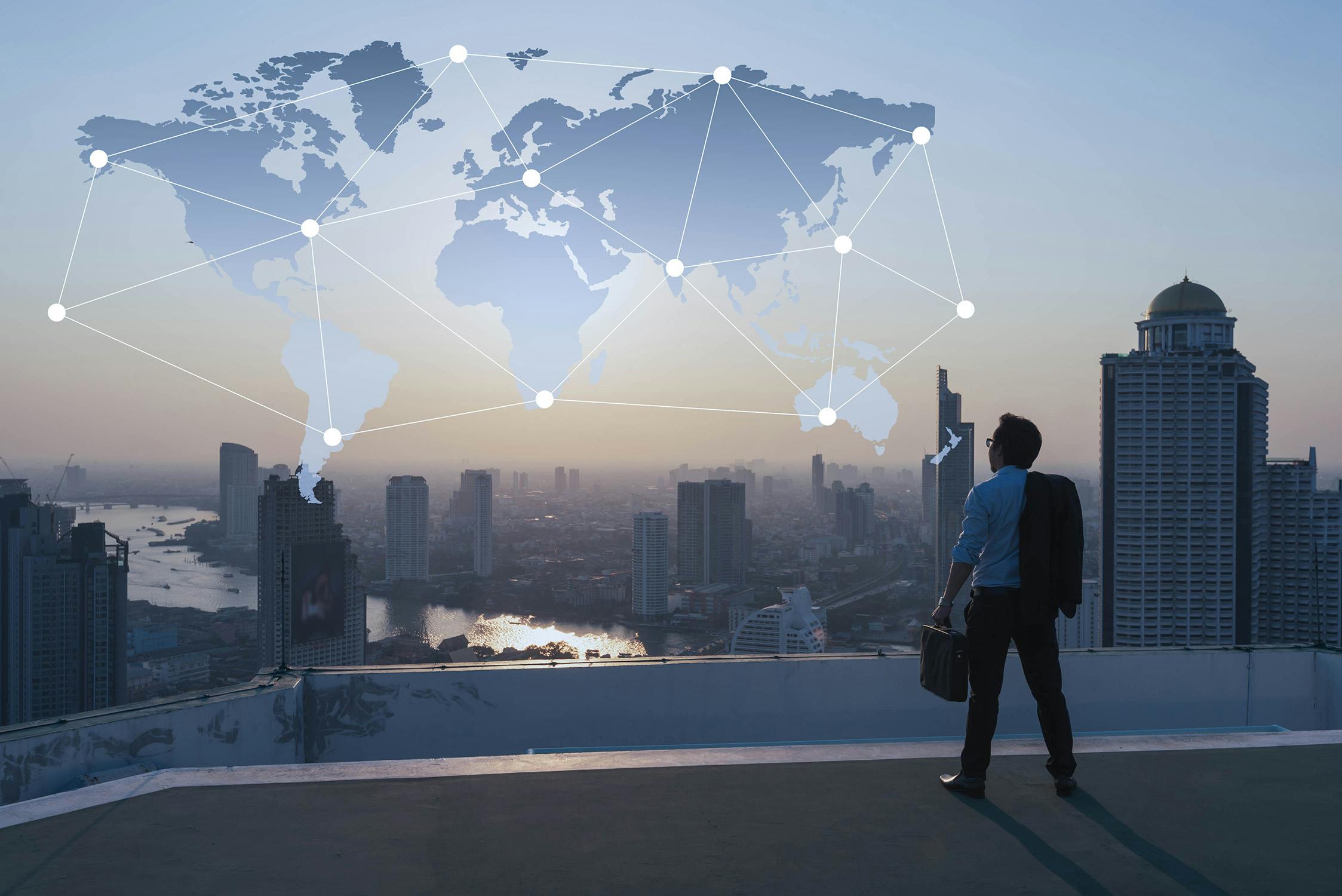 Get a global viewpoint with VOSS full stack observability for your UC environment. Businessman stand on roof top of building, globalization conceptual