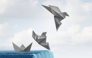 Image of a folded paper boat near waterfall edge transforming into a paper bird in flight - Transforming Enterprise Telephony blog