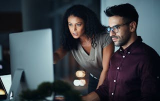 Business people, computer and night team work with planning, collaboration or problem solving at tech company. Developer, programmer and leader with serious for software support and web solution