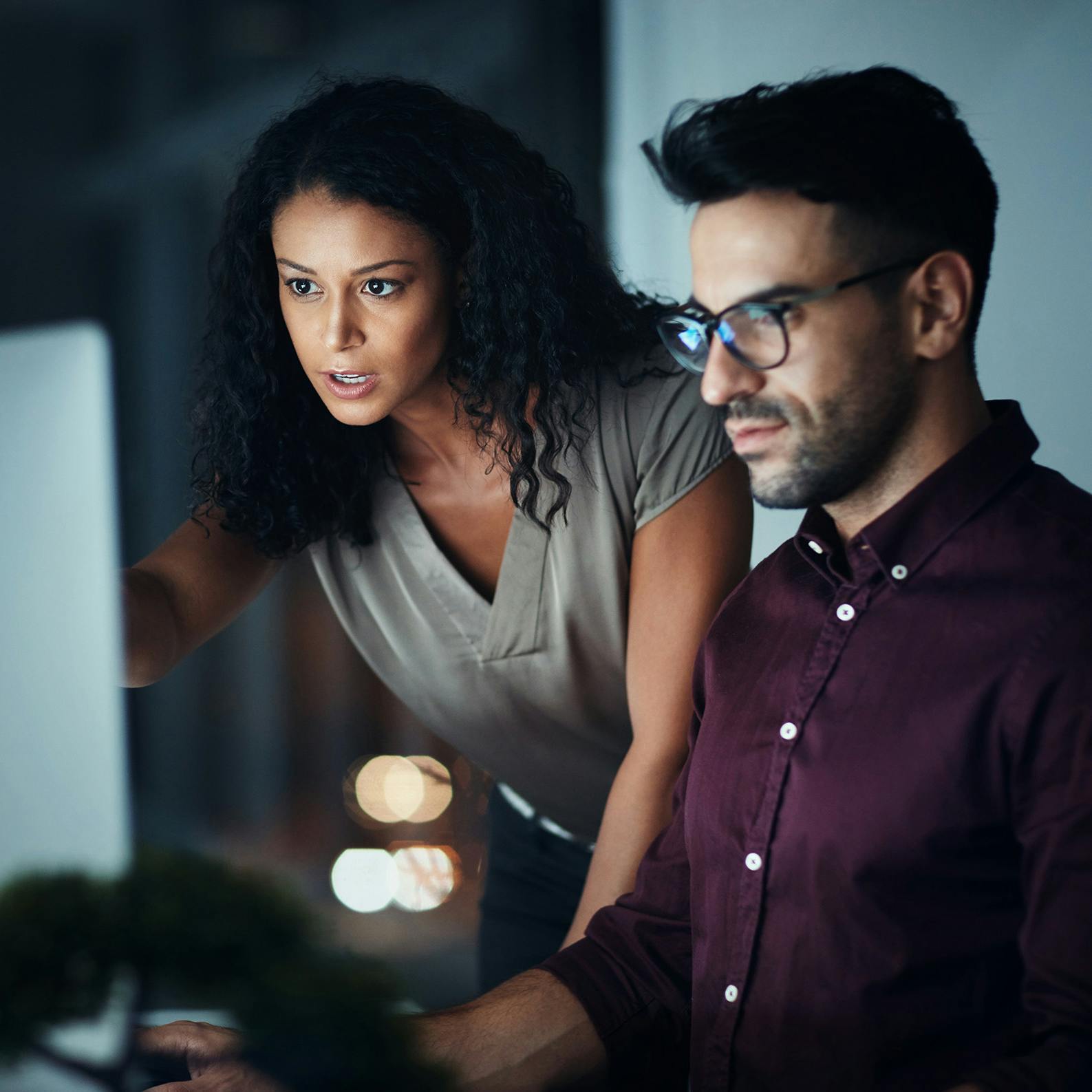 Woman and man having meeting looking at laptop