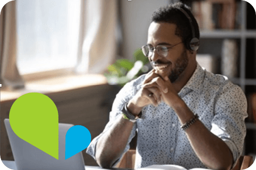 Young business man smiling at laptop
